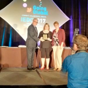 Christine Chapman, Economic Development Officer with the City of Guelph, accepts the award of excellence for Mind Your Business.