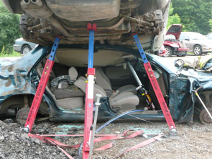 Car Rescue Jacked up car reveals the passenger side of the bottom car