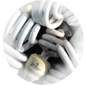 What is the proper way to dispose of fluorescent light bulbs?