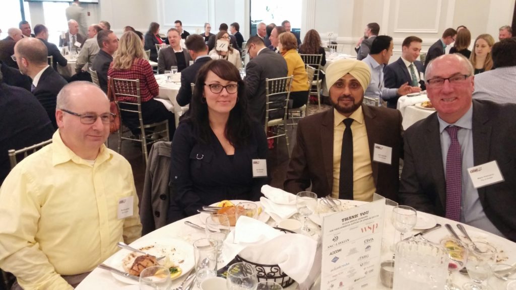 Picture of City of Guelph employees sitting at a table at the awards ceremonies. From left to right, the people pictured are L to R: Rob Broughton, project manager facilities, Jean Starchuk, project manager facilities, Jeet Joginder, manager complex capital projects, Mario Petricevic, general manager facilities management