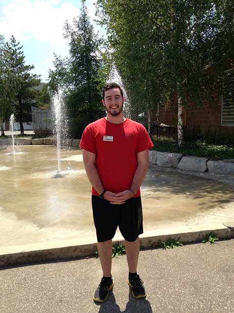 Alex standing in front of a splash pad