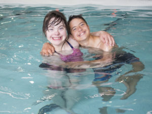 two children swimming in a pool