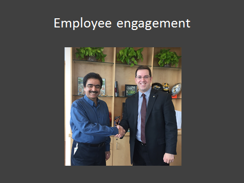Employee Engagement - Employee Mohsin Talpur shaking hands with Mayor Cam Guthrie