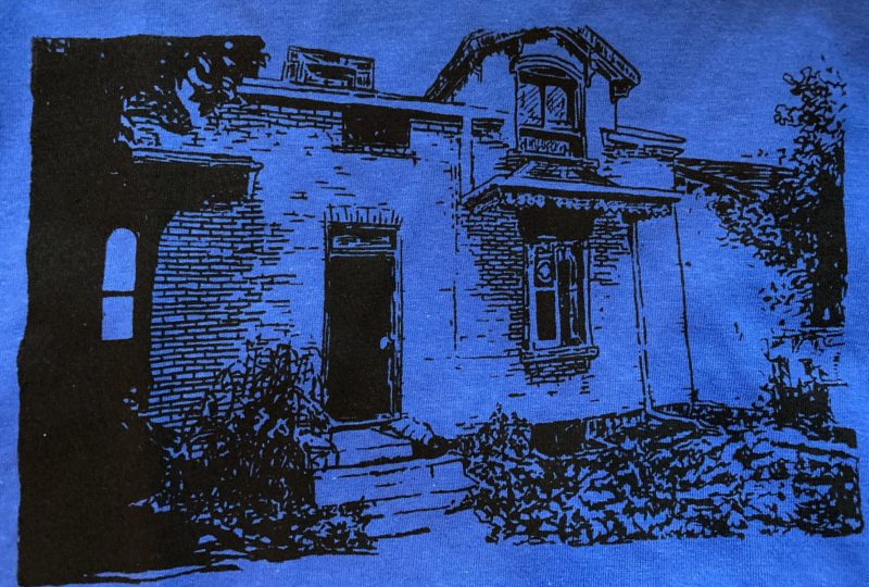 A photo of the drawing above silkscreened onto a blue t-shirt.