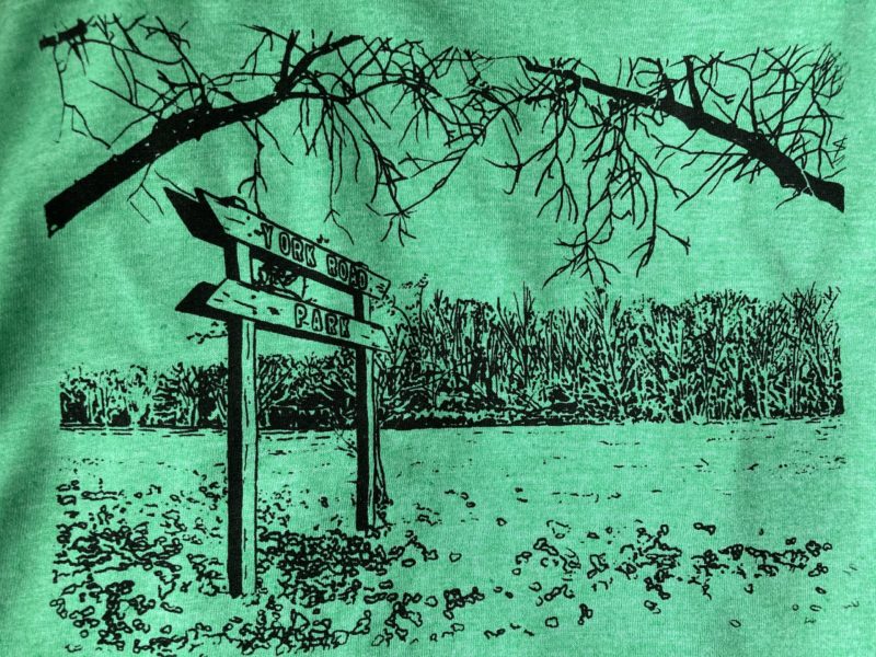 A photo of the drawing above silkscreened onto a green t-shirt.