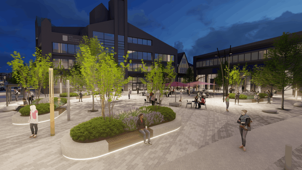 Nighttime view of an illuminated urban plaza with trees, benches, and landscaped planters. People are sitting and walking throughout the space, which includes tables under purple umbrellas. Modern buildings with large windows surround the plaza, and warm lighting highlights pathways and seating areas. The sky is dark blue with scattered clouds.