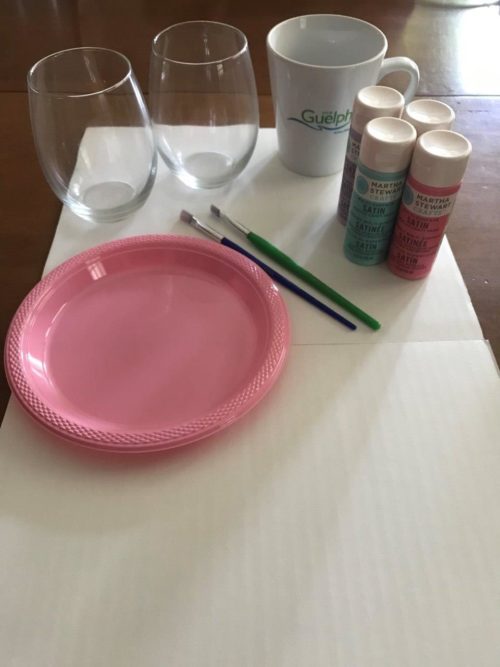 2 glasses, a mug, paint, paintbrush and paper plate