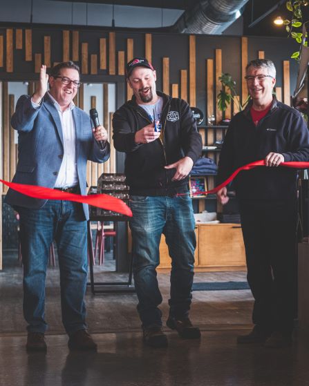 Mayor Cam Guthrie, Cam Fryer and MP Lloyd Longfield cutting the red ribbon at Royal City Brewery