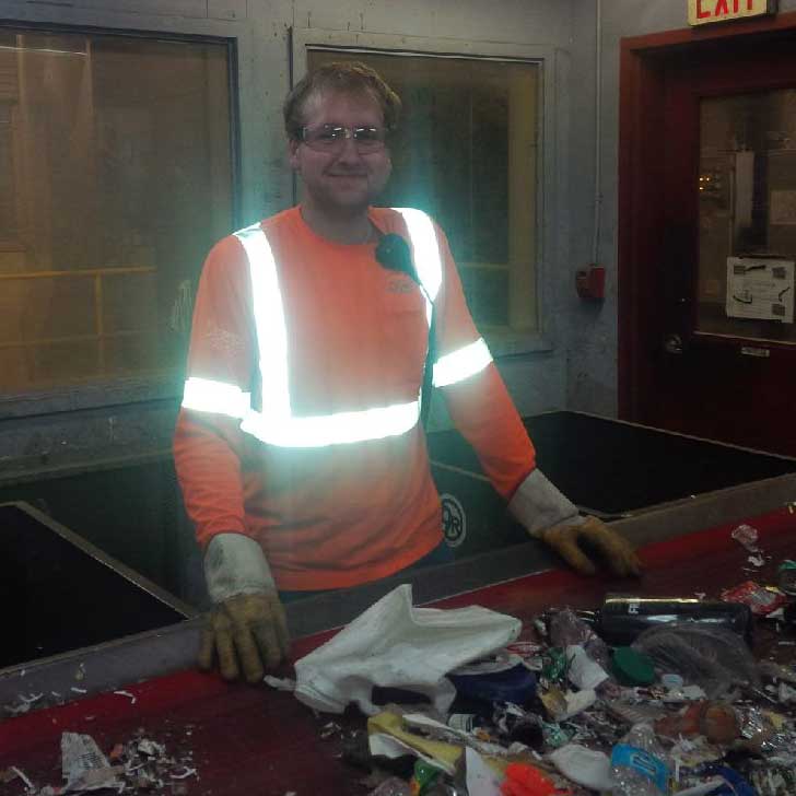 Samuel sorting waste at the Material Recovery Facility
