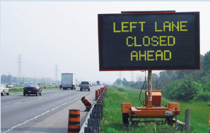 Roadside electronic sign stating Left Lane Closed Ahead