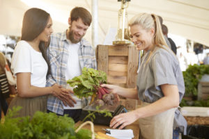 A man and woman shopping for produce