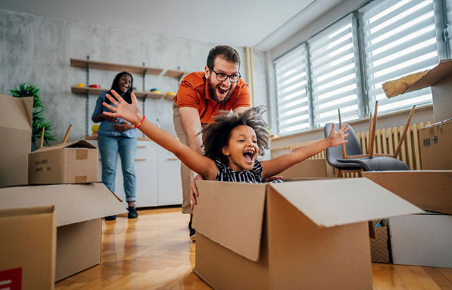 a family unpacking boxes