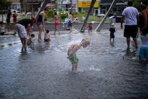 Child splashing at market square