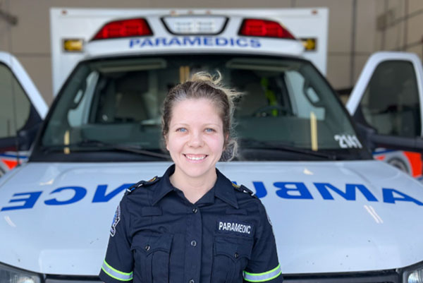 paramedic standing in front of an ambulance