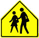 Yellow pentagon sign with a boy and girl walking